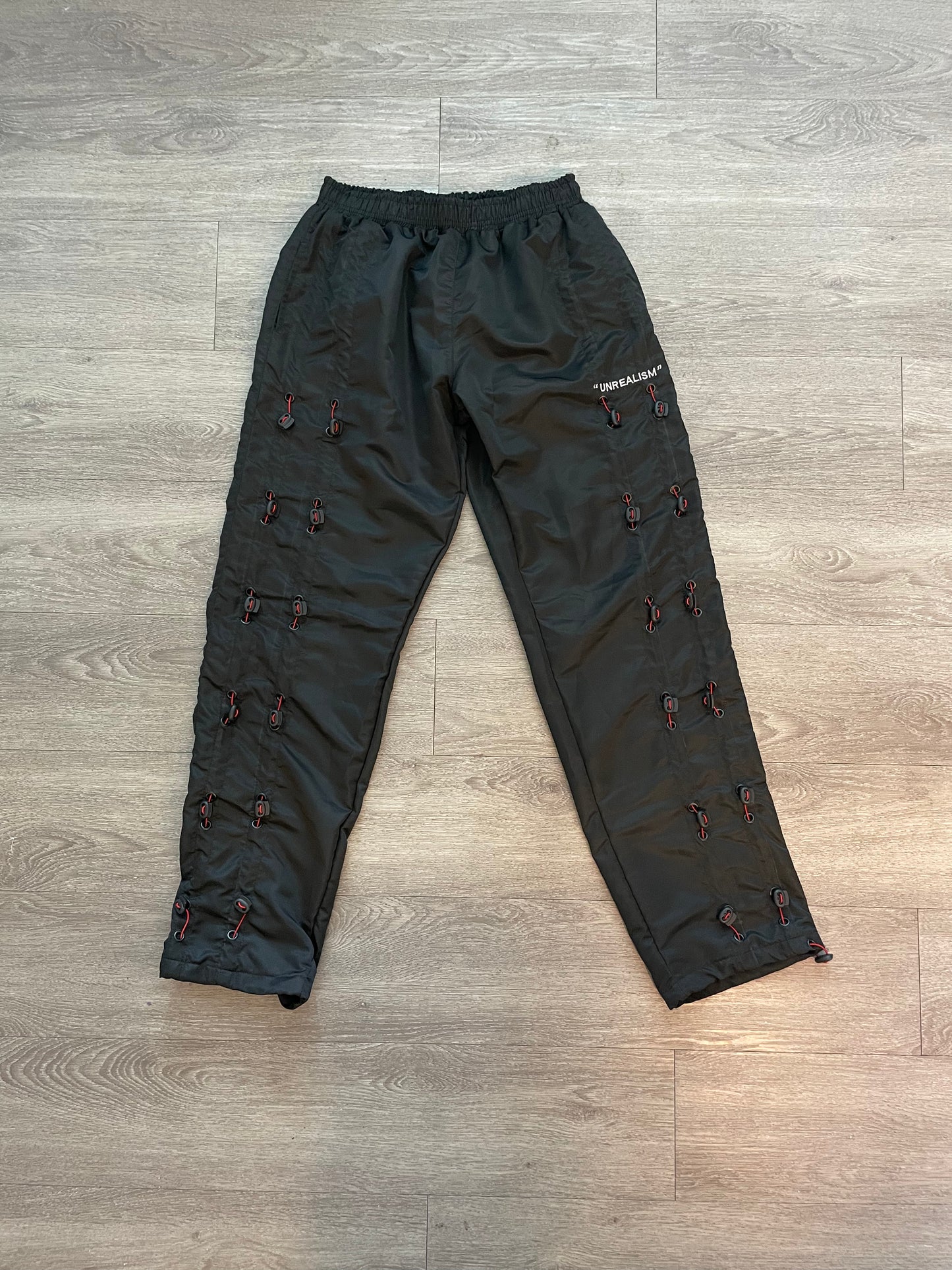 "UNREALISM" ZIP TIE GALORE  PANTS (Unisex)